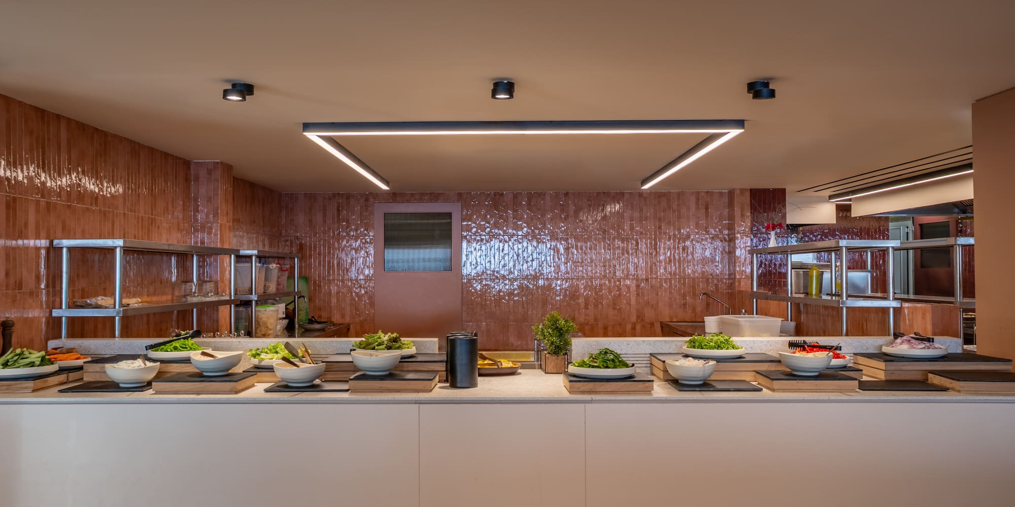 Modern self-serve salad bar buffet with fresh greens and ingredients.