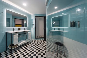 a bathroom with a mirror and a shower