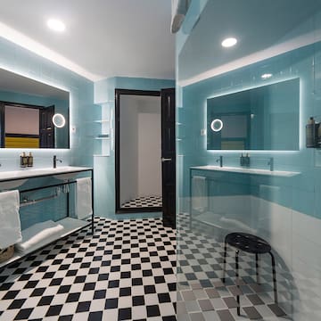 a bathroom with a mirror and a shower