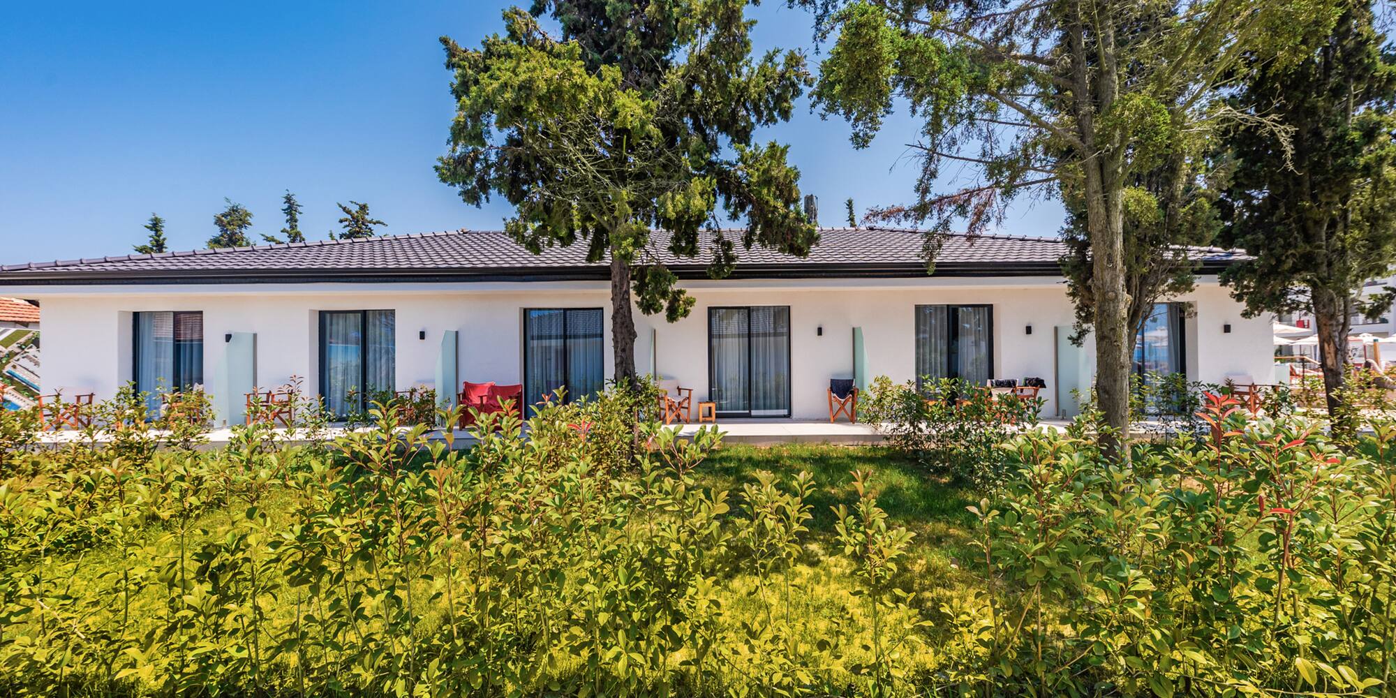 a white house with trees and grass