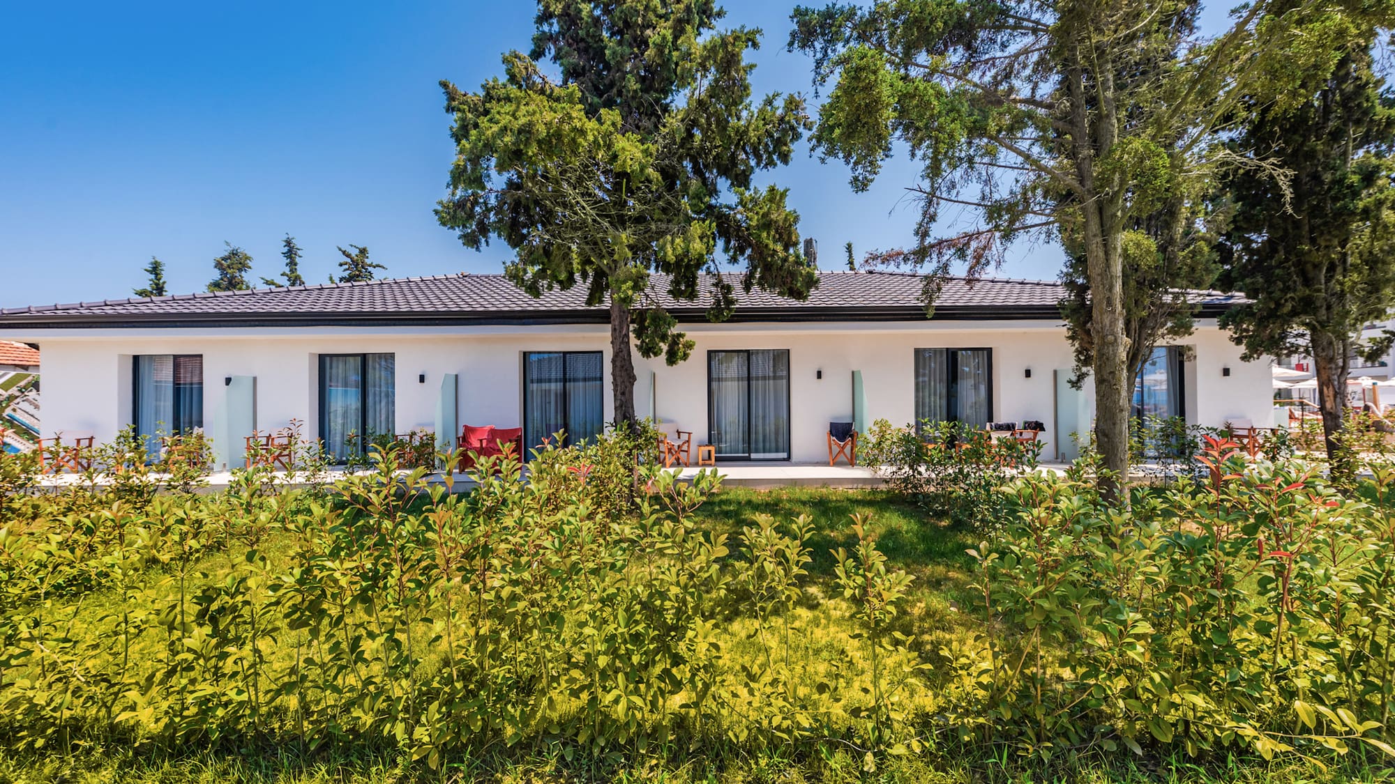 a white house with trees and grass