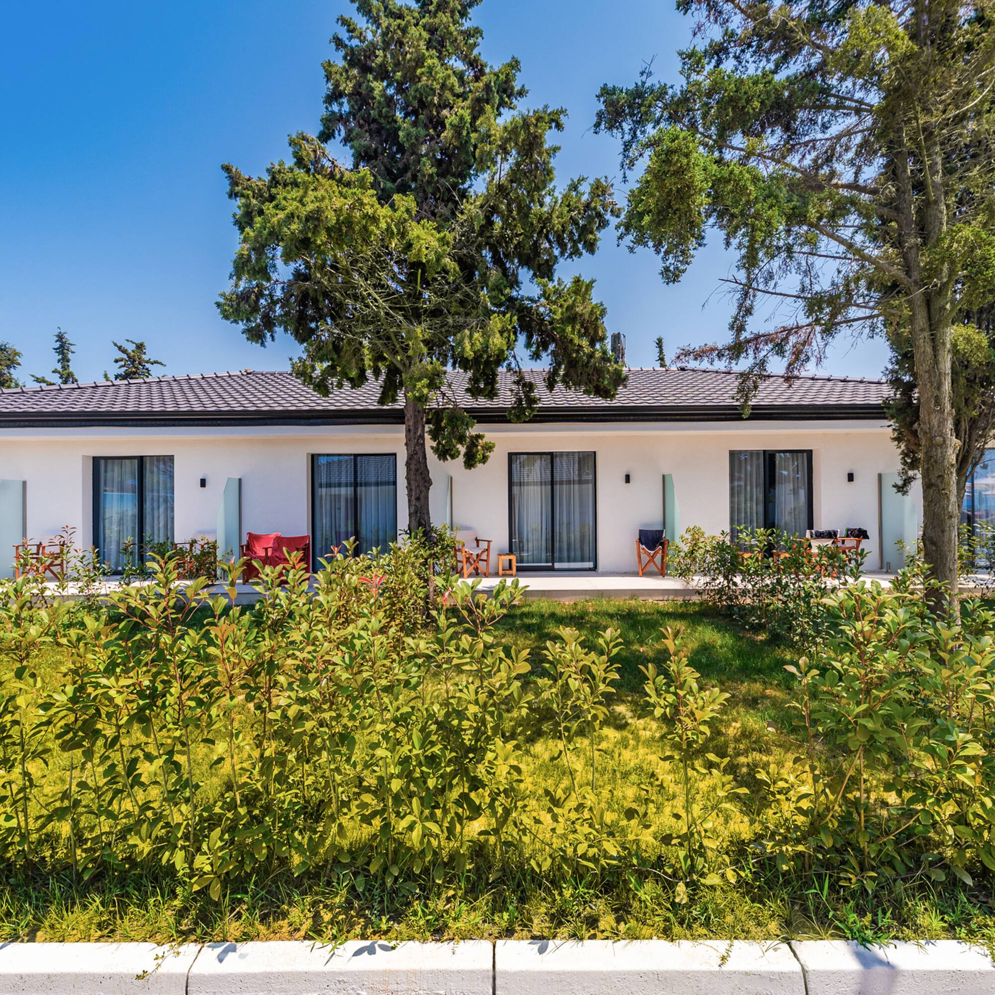 a white house with trees and grass