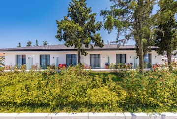 a white house with trees and grass