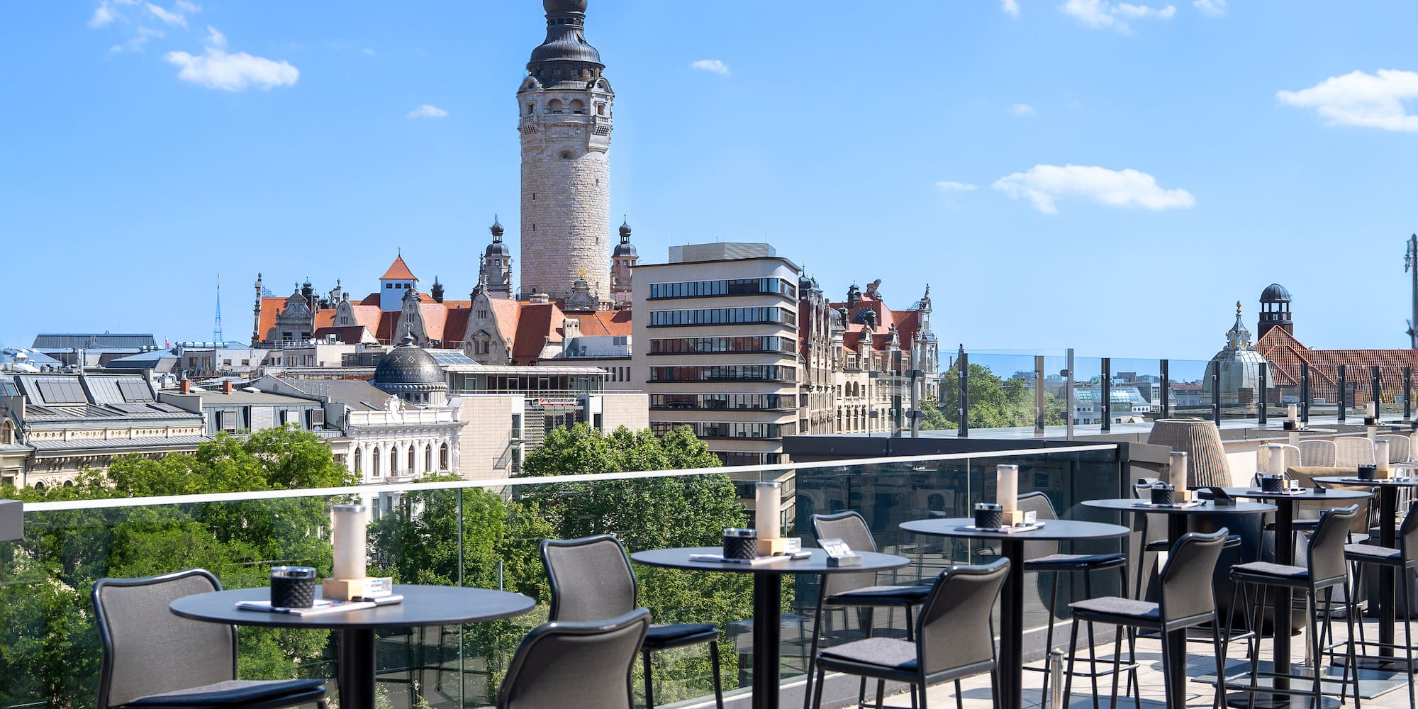 Leipzig rooftop terrace overlooking city skyline and New Town Hall tower.