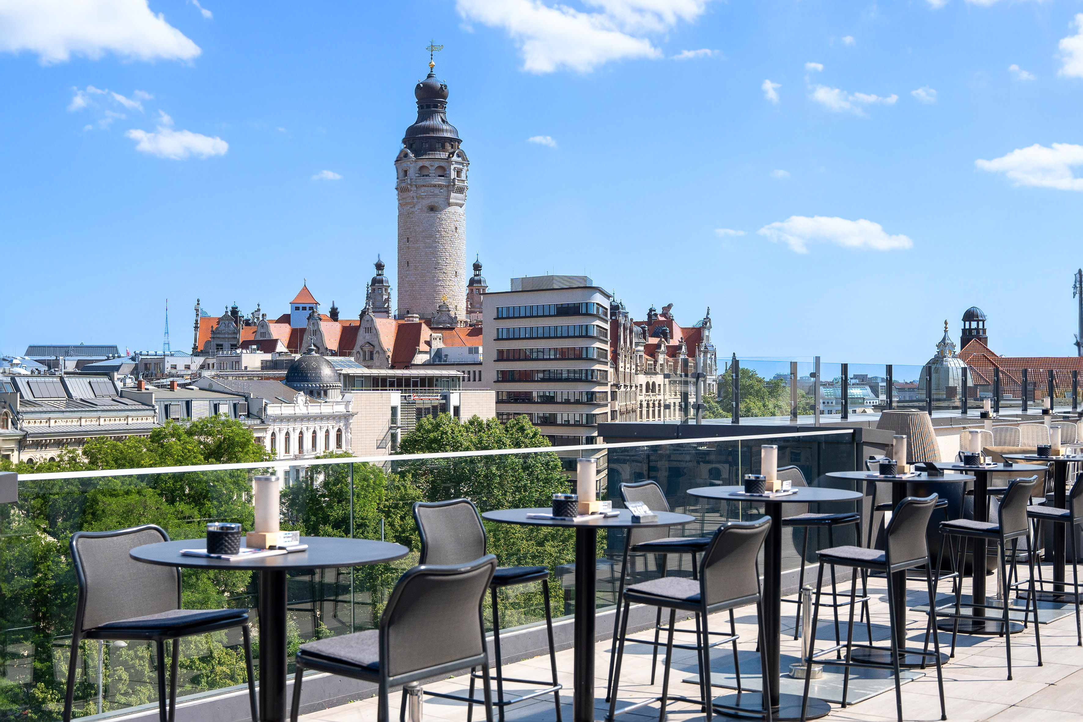 Leipzig rooftop terrace overlooking city skyline and New Town Hall tower.