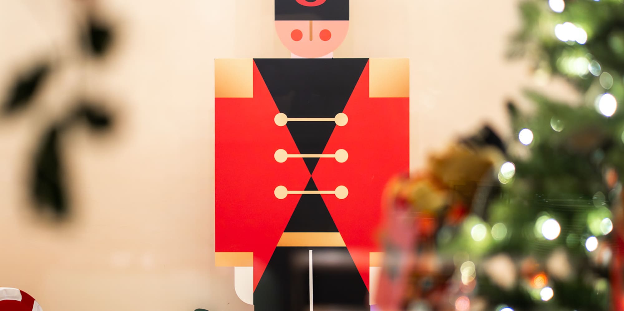 a christmas tree with lights and a toy soldier