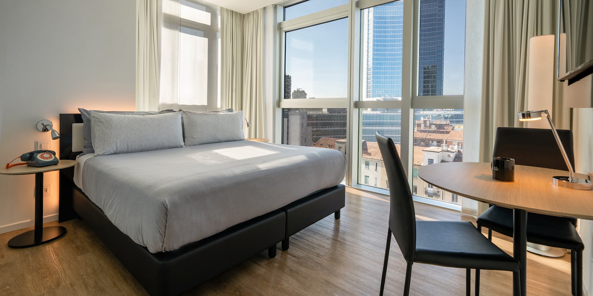 a room with a bed and a table and chairs