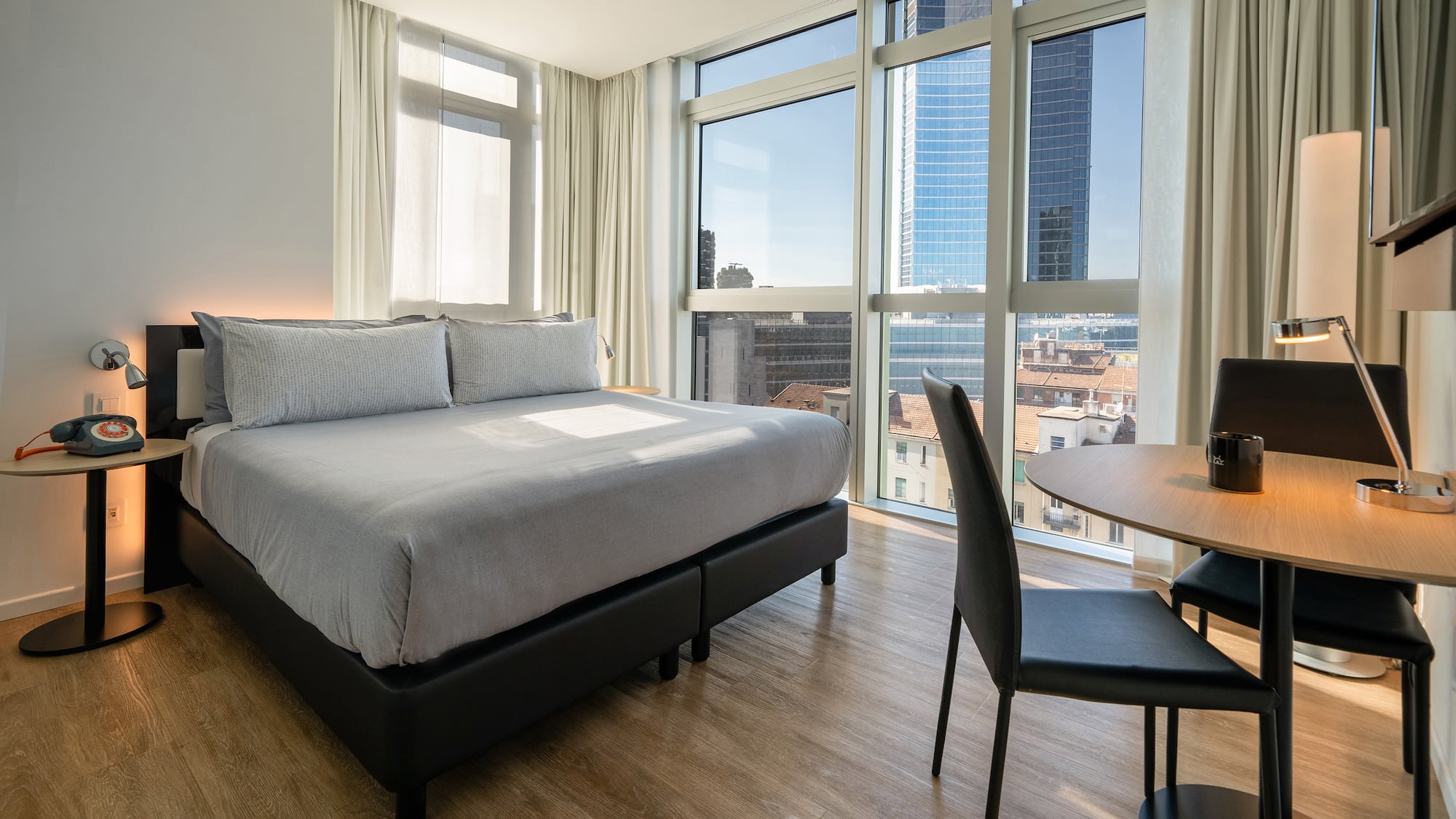 a room with a bed and a table and chairs