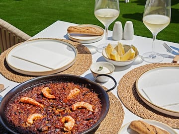 a table with food and glasses of wine