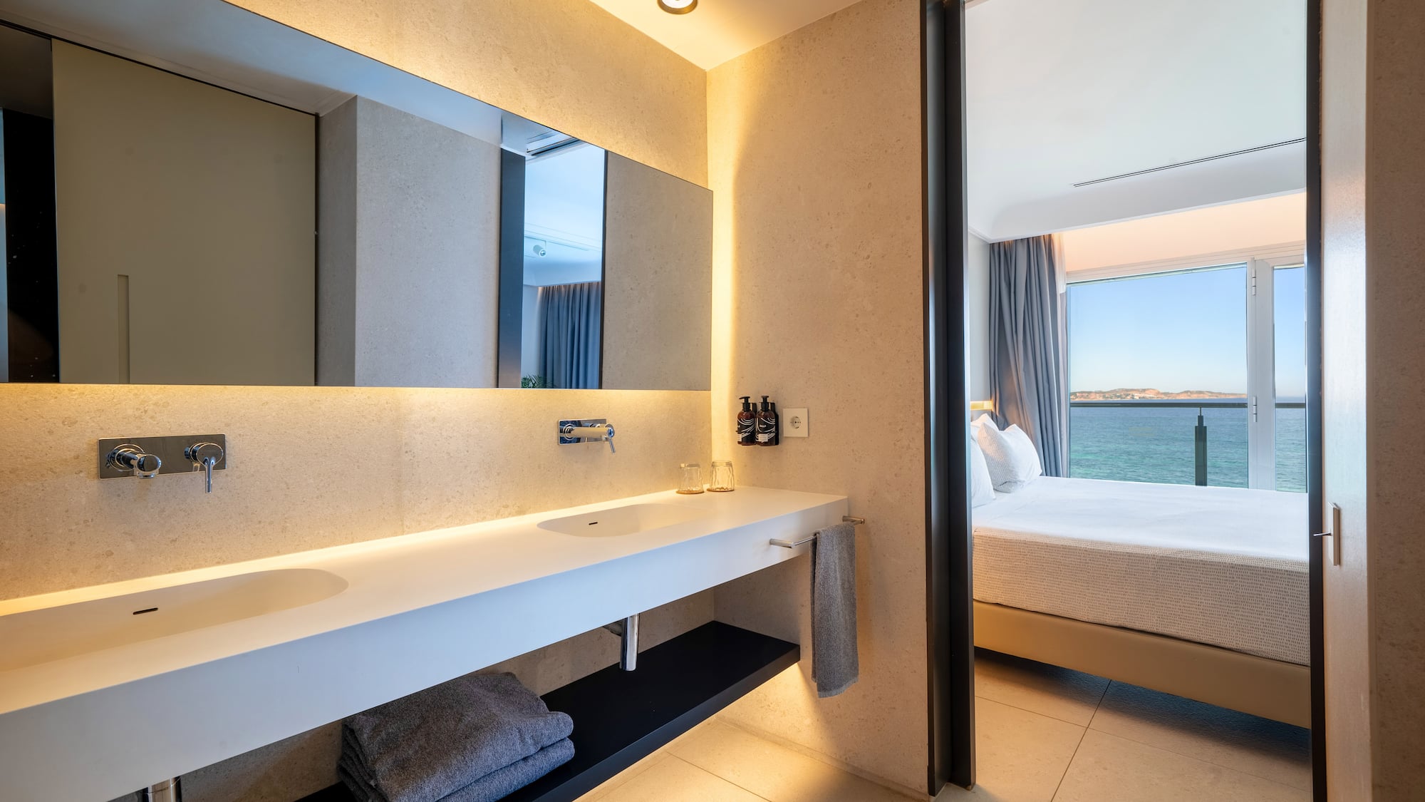 a bathroom with a large mirror and a large sink