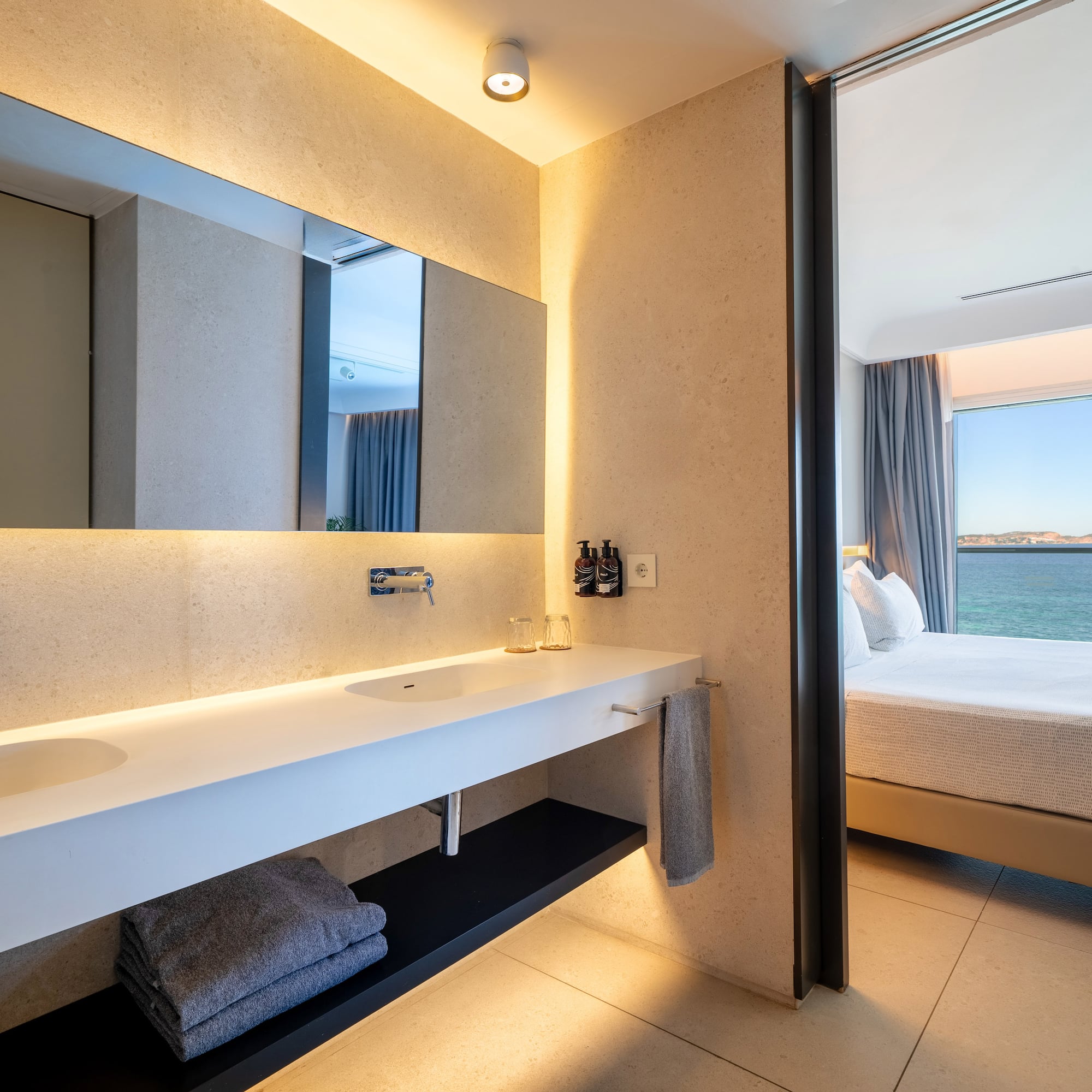 a bathroom with a large mirror and a large sink