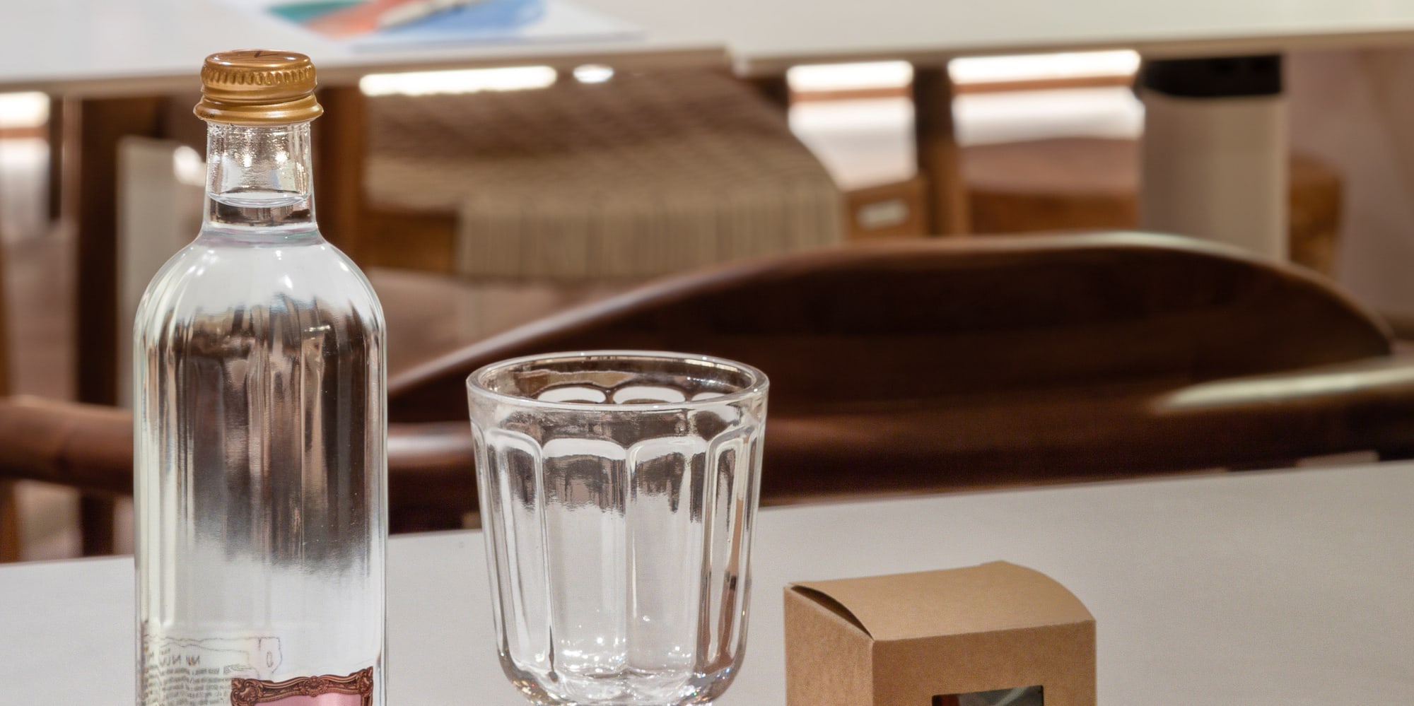 a bottle and glass on a table