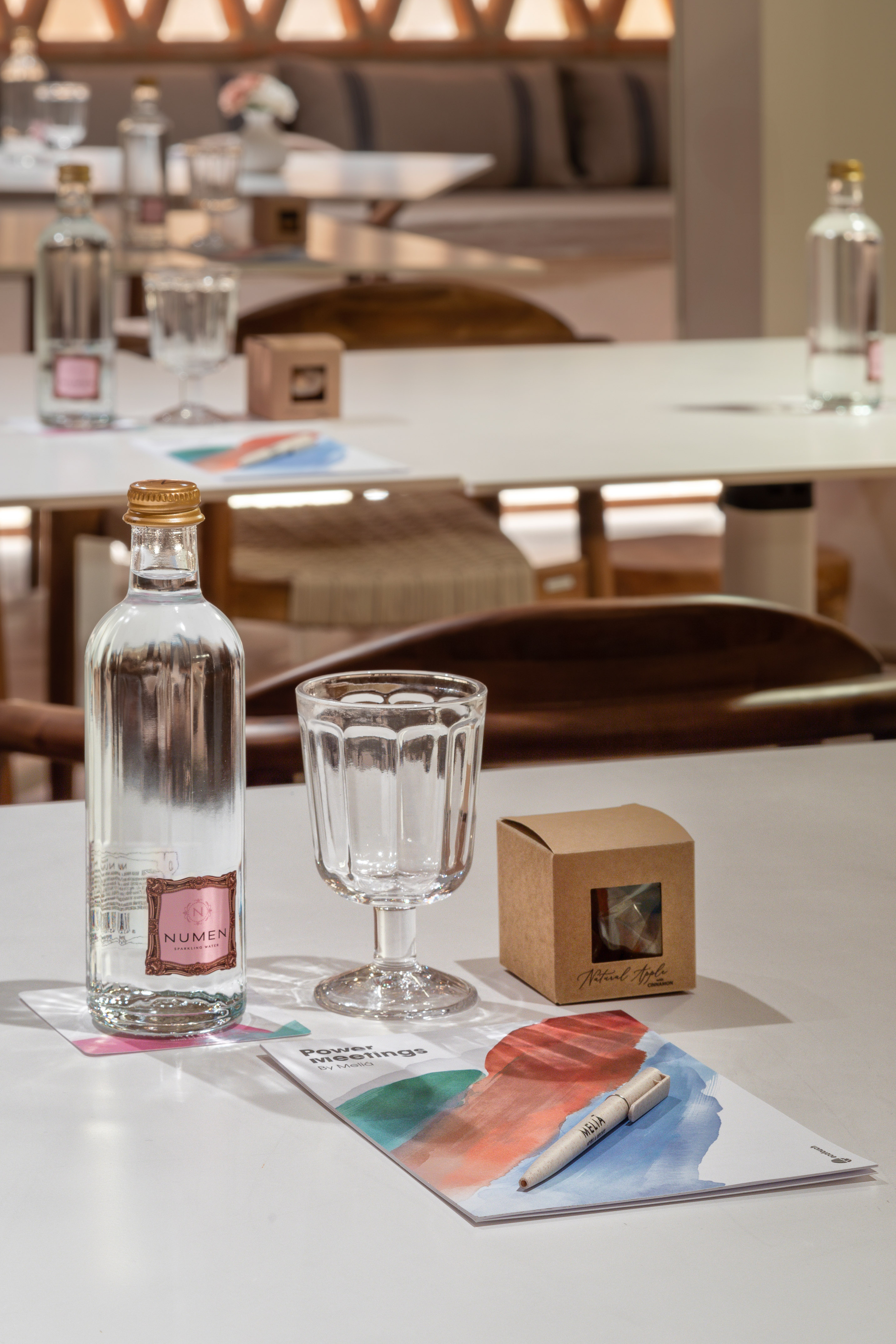 Melia "Power Meetings" table: Numen sparkling water, glass, brochure, gift box.