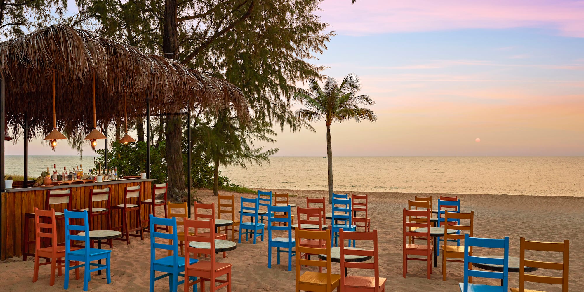a beach with tables and chairs