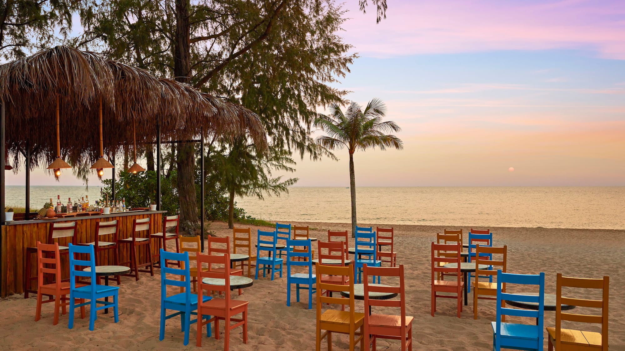 a beach with tables and chairs