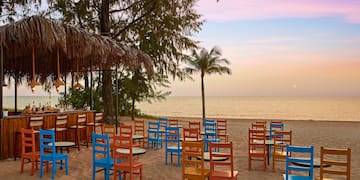 a beach with tables and chairs
