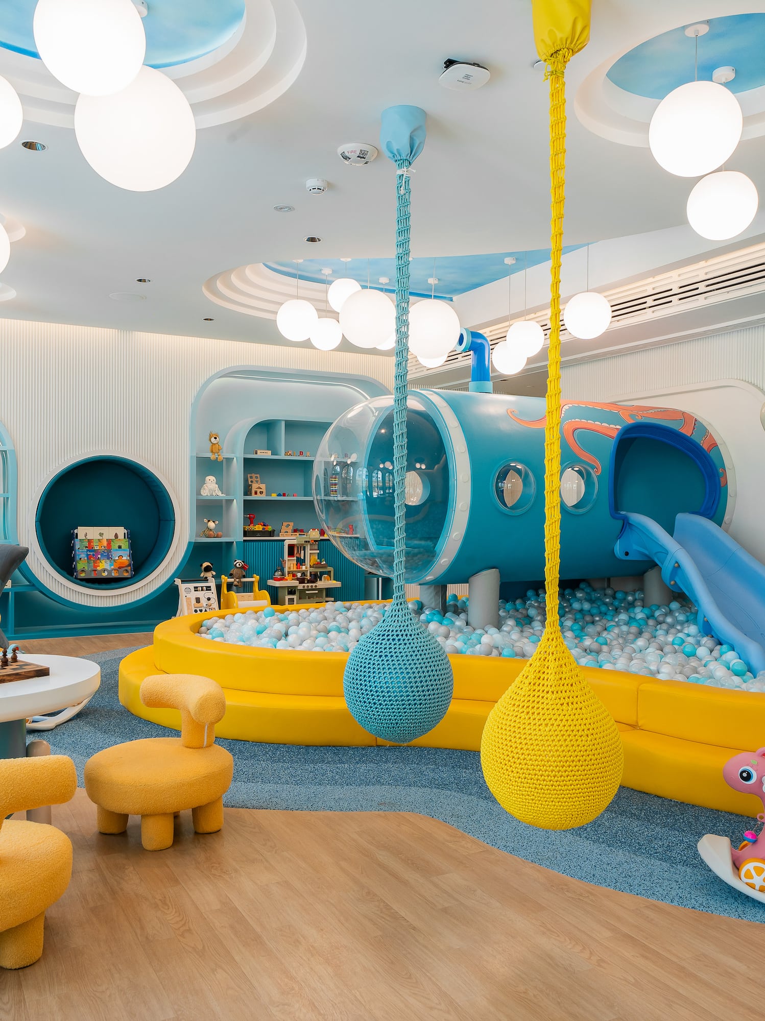 a room with a play area and a slide