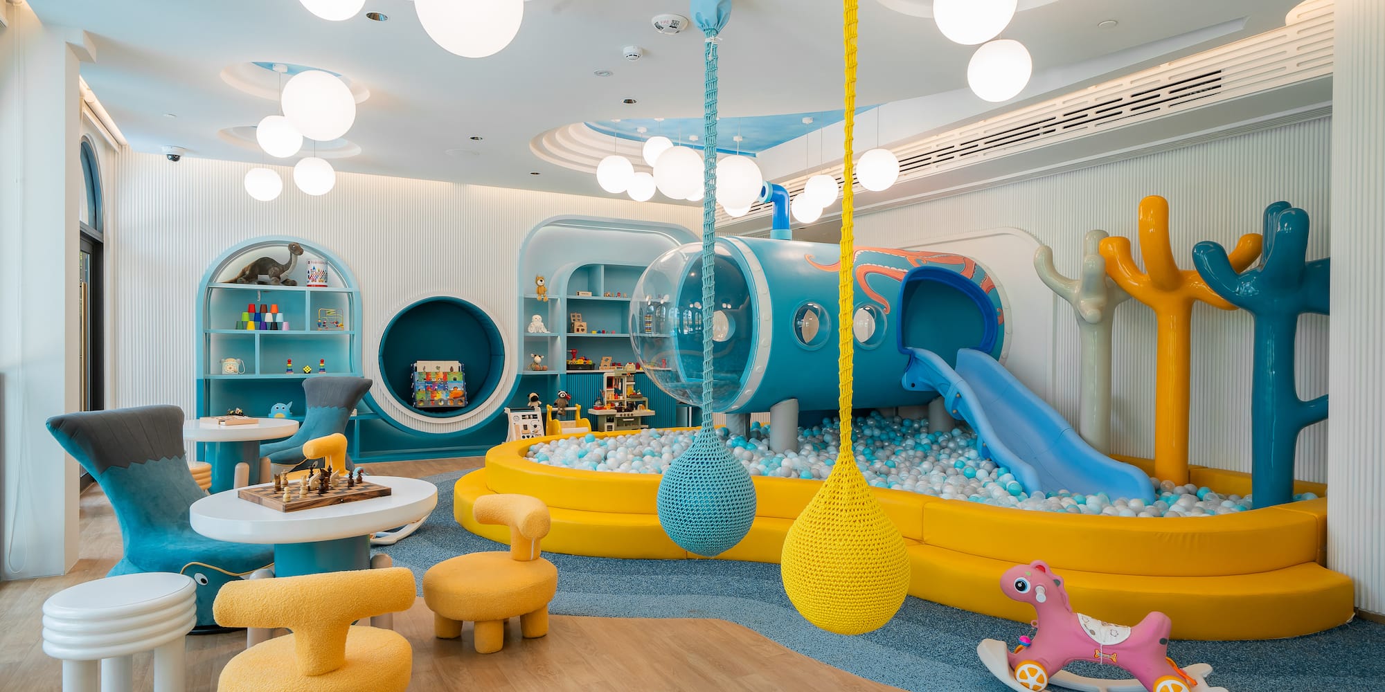 a room with a play area and a slide
