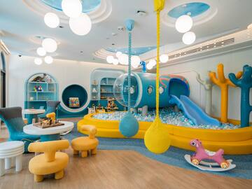 a room with a play area and a slide