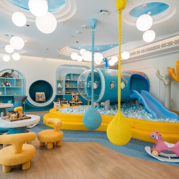 a room with a play area and a slide