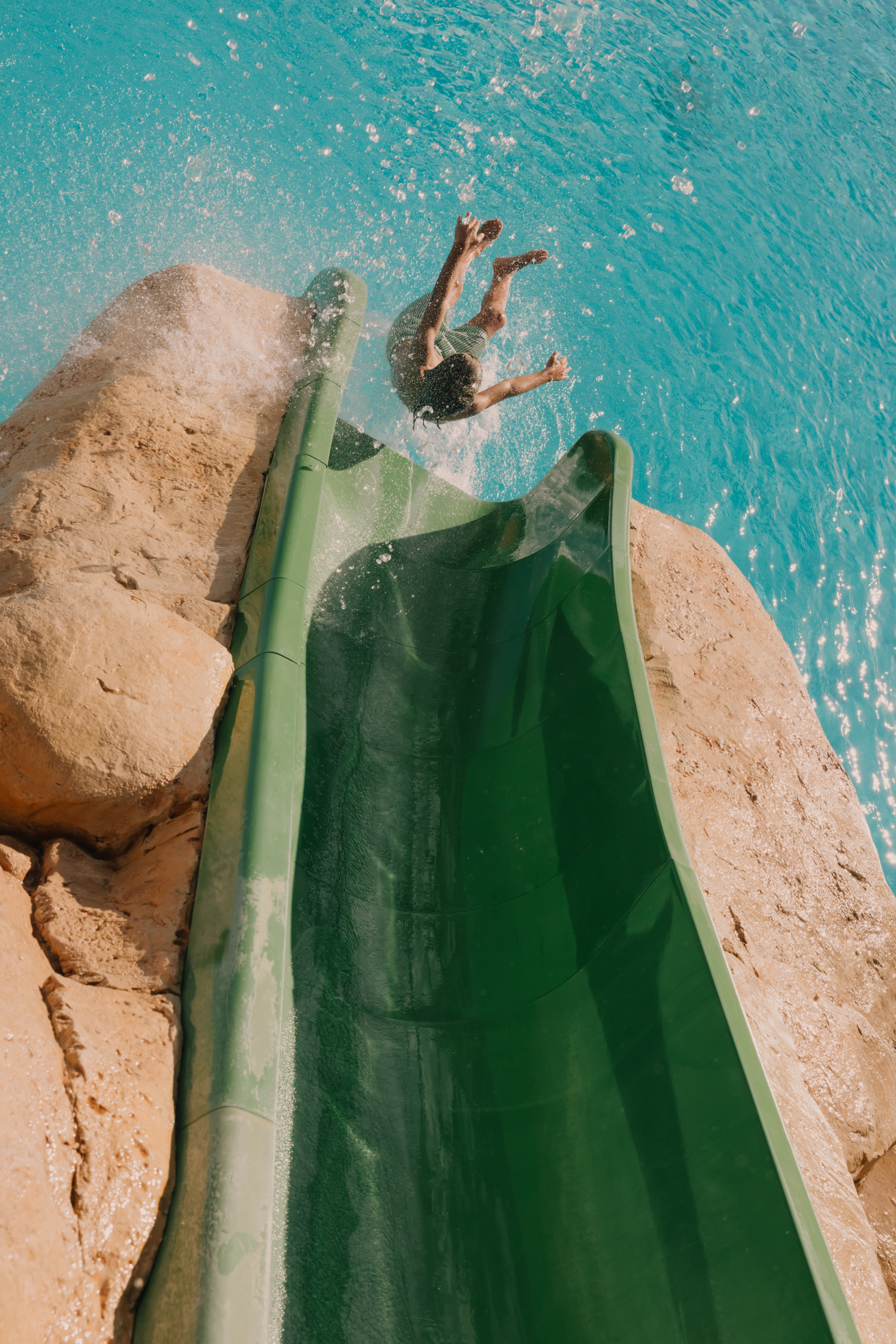 a person jumping into a water slide