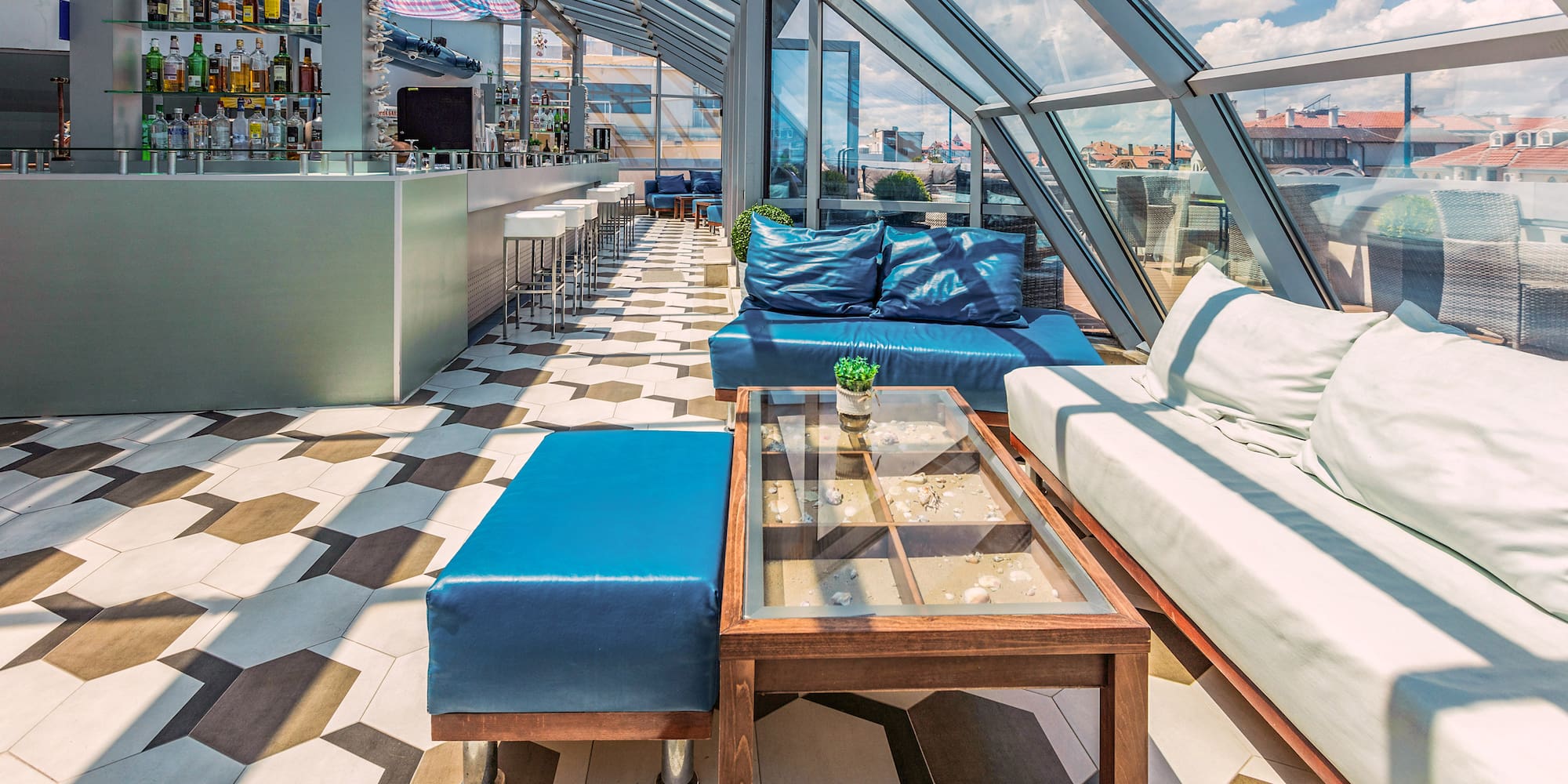 a room with a glass roof and a table and couches