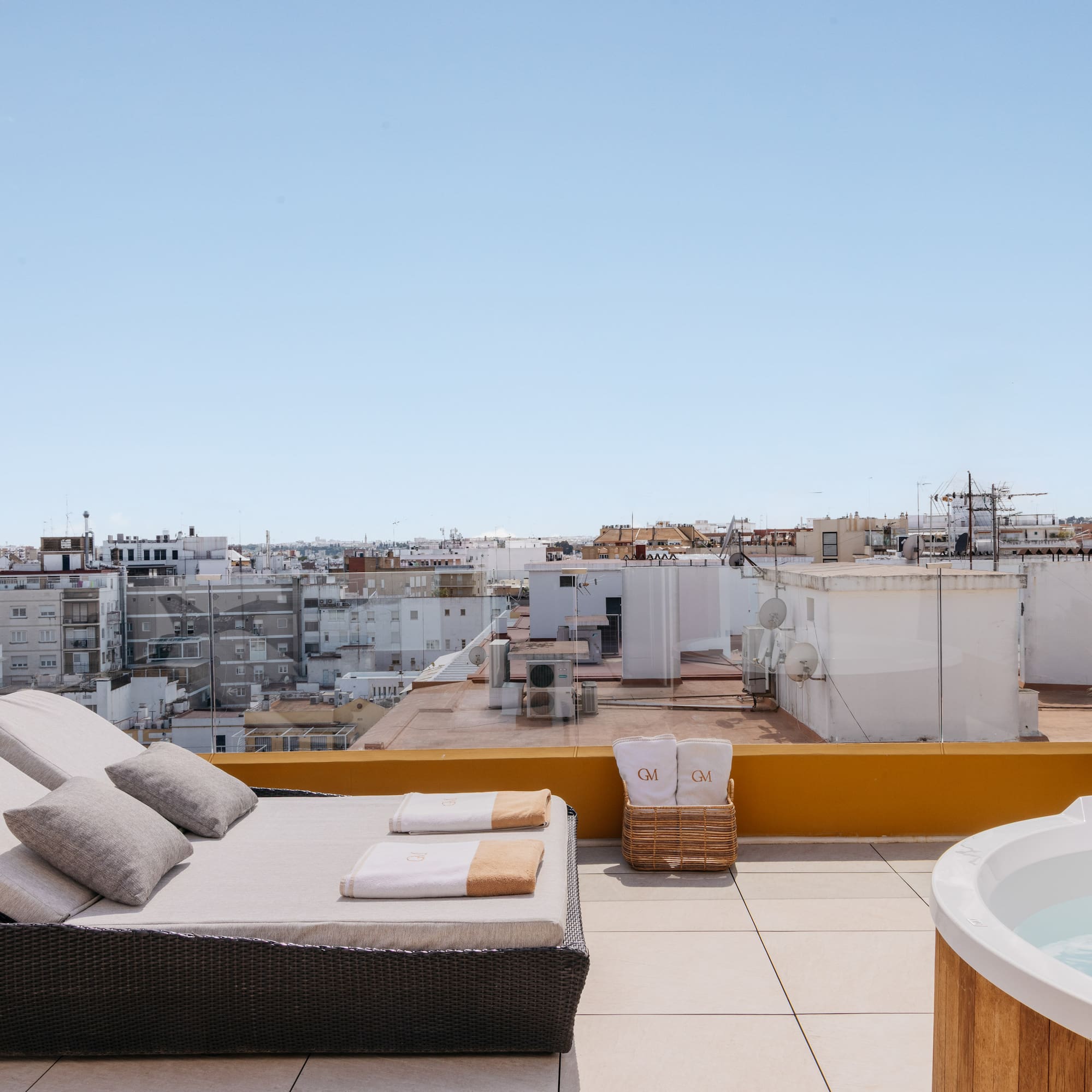 a hot tub on a rooftop with a couch and a hot tub