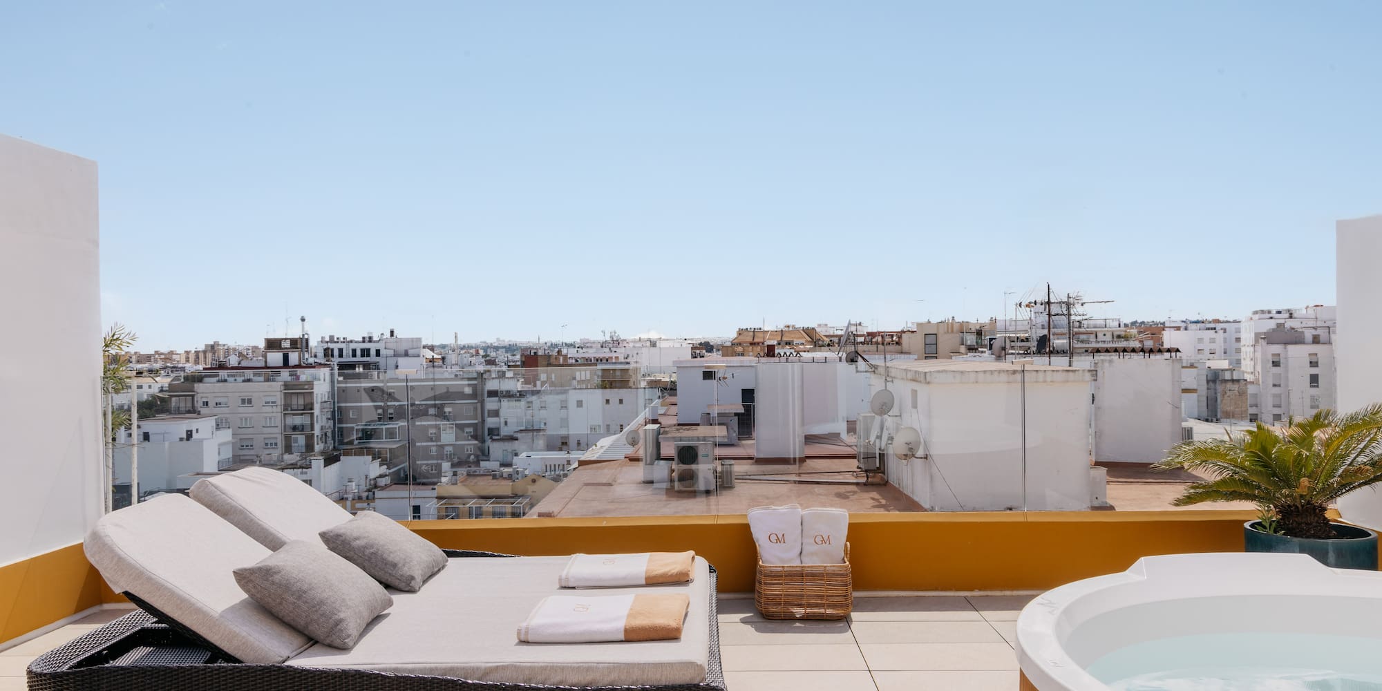 a hot tub on a rooftop with a couch and a hot tub
