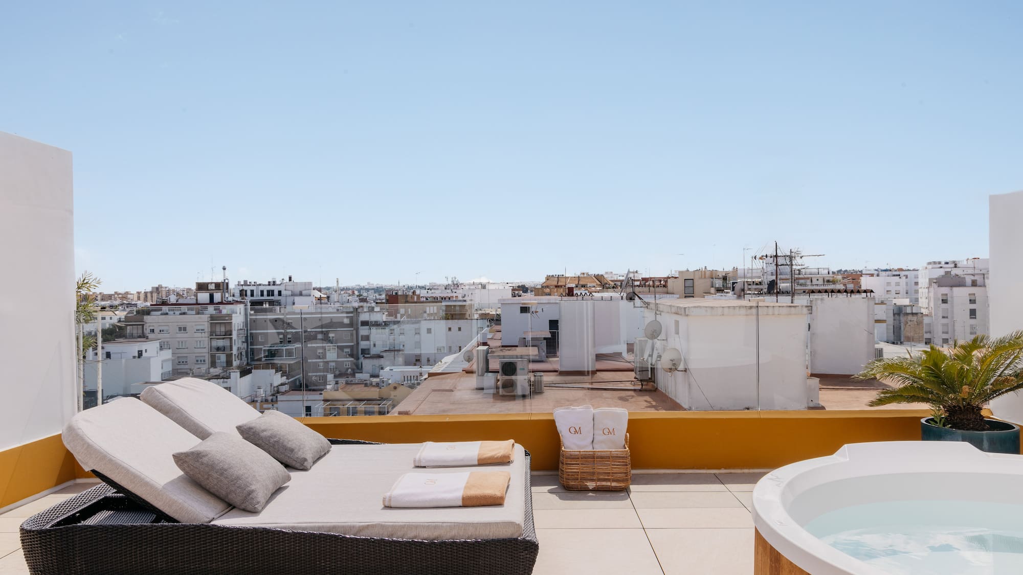 a hot tub on a rooftop with a couch and a hot tub