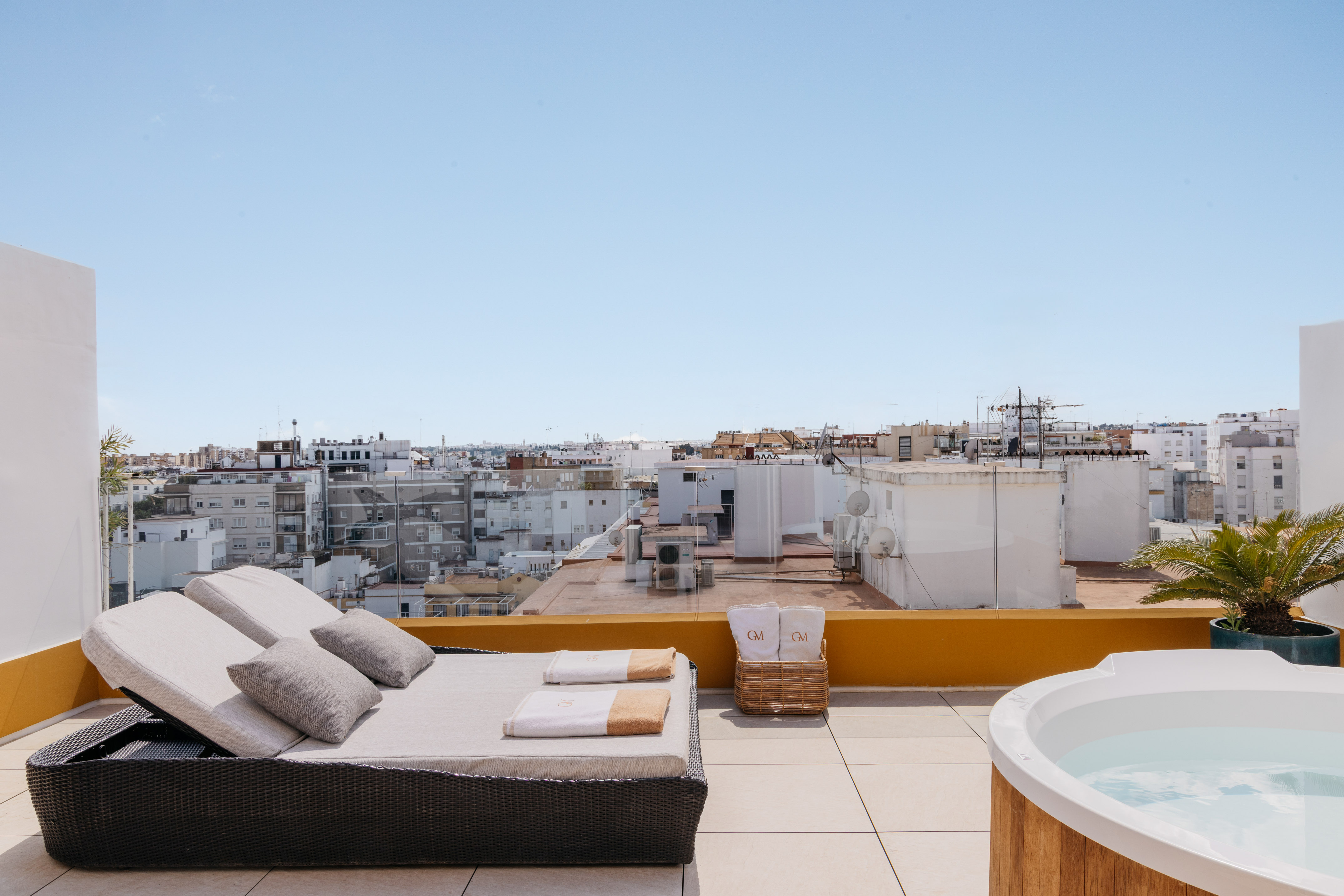 a hot tub on a rooftop with a couch and a hot tub