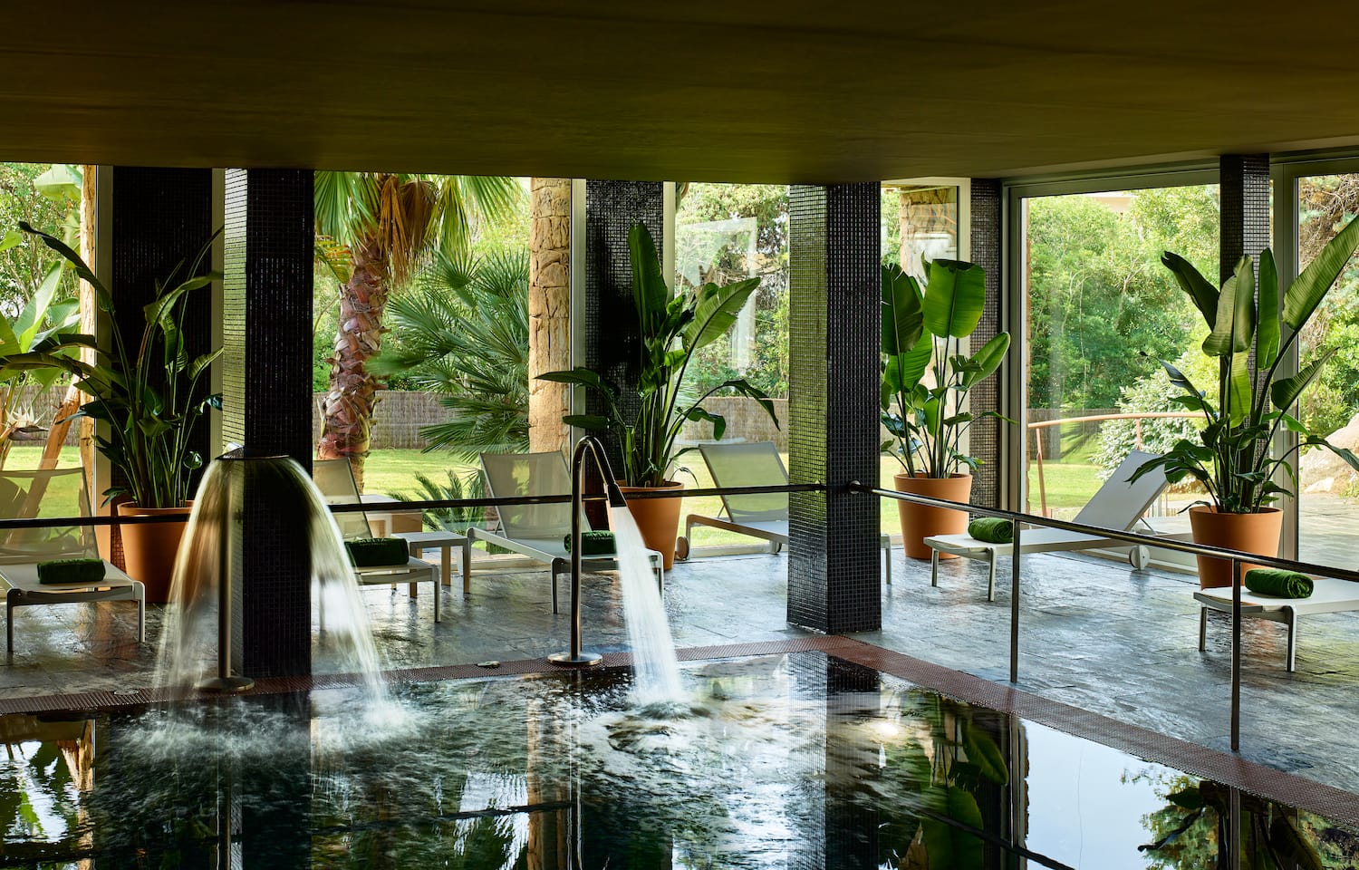 a pool with a waterfall in the middle of it