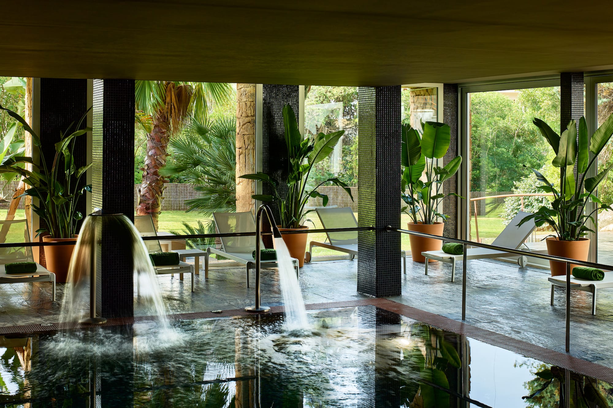 a pool with a waterfall in the middle of it