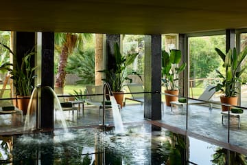 a pool with a waterfall in the middle of it