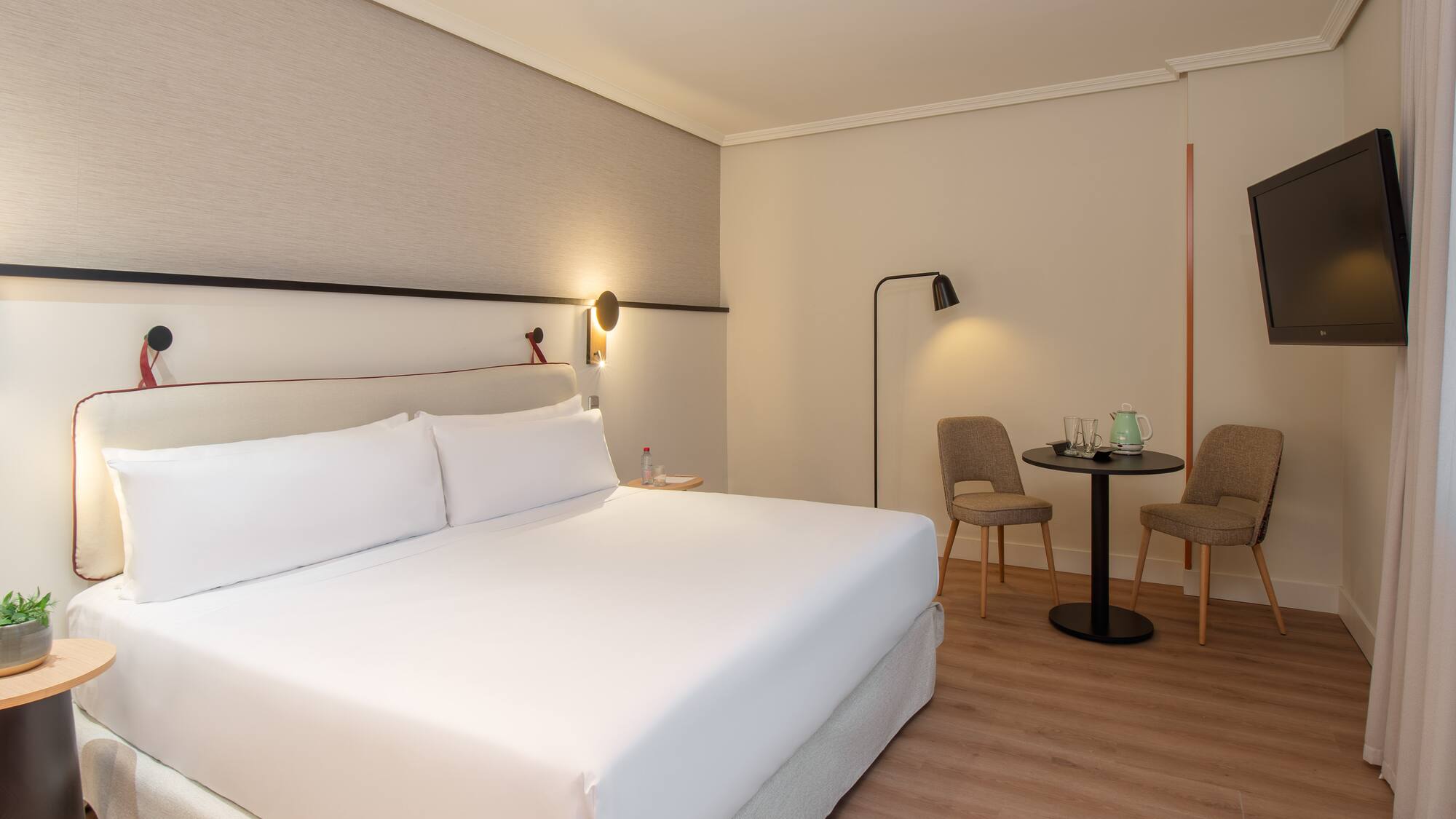 a hotel room with a bed and chairs