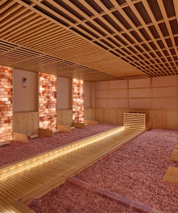 a room with a wooden floor and brick walls