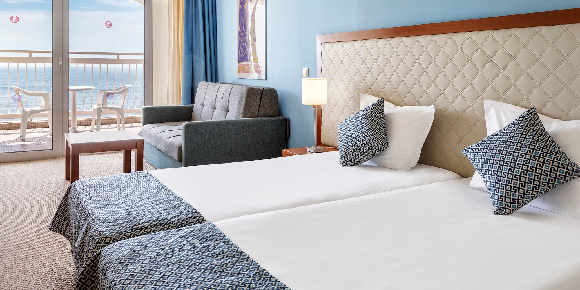 a hotel room with two beds and a couch