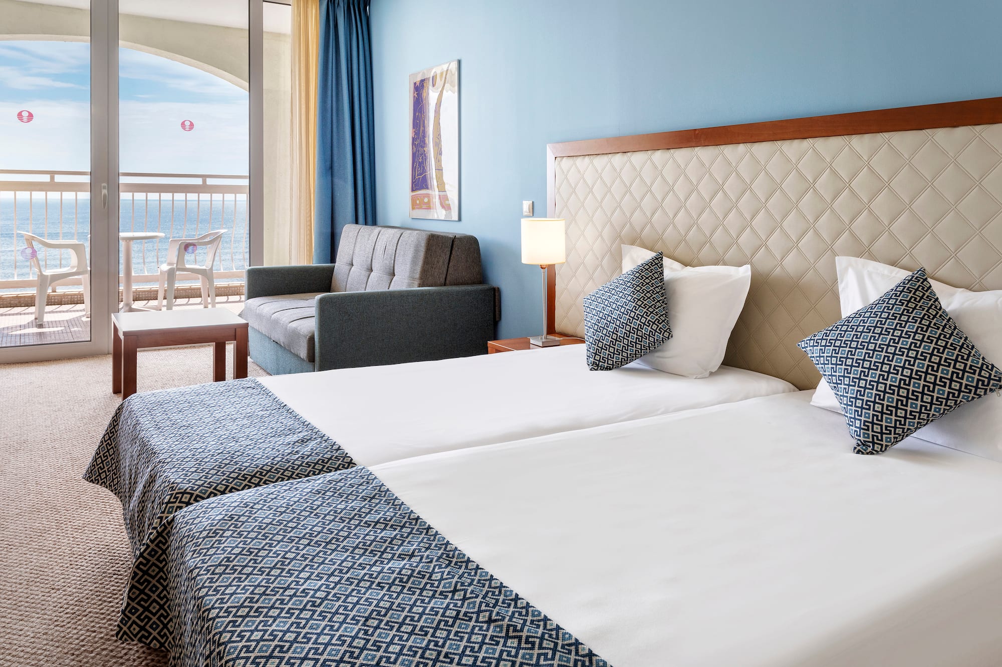 a hotel room with two beds and a couch