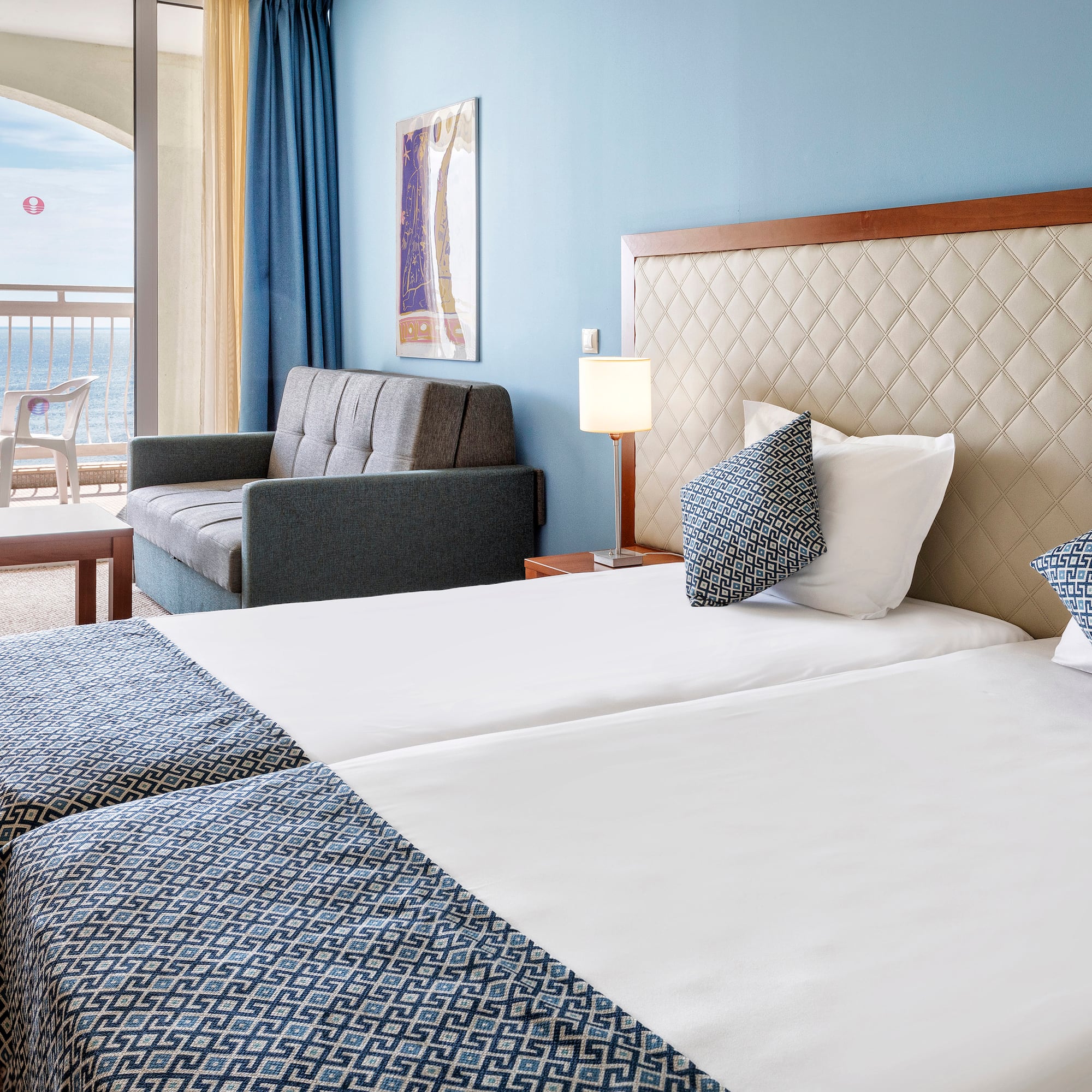 a hotel room with two beds and a couch