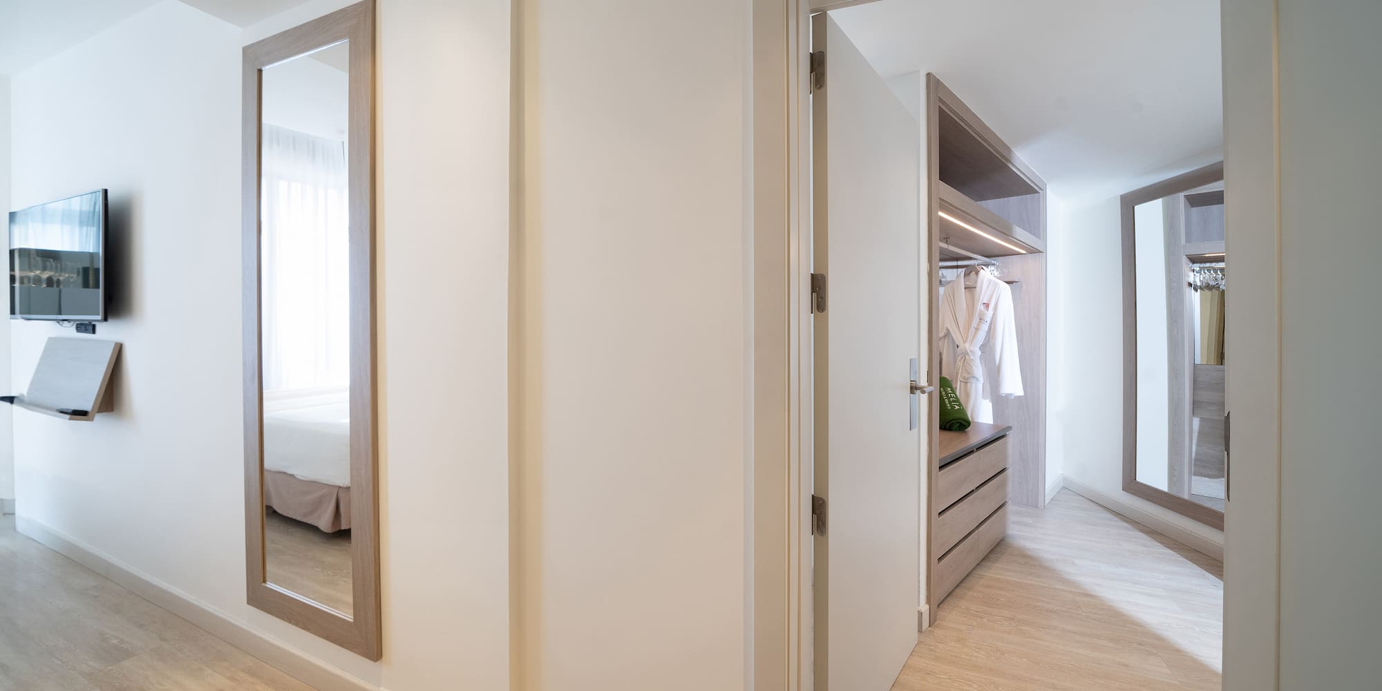 a hallway with a mirror and closet