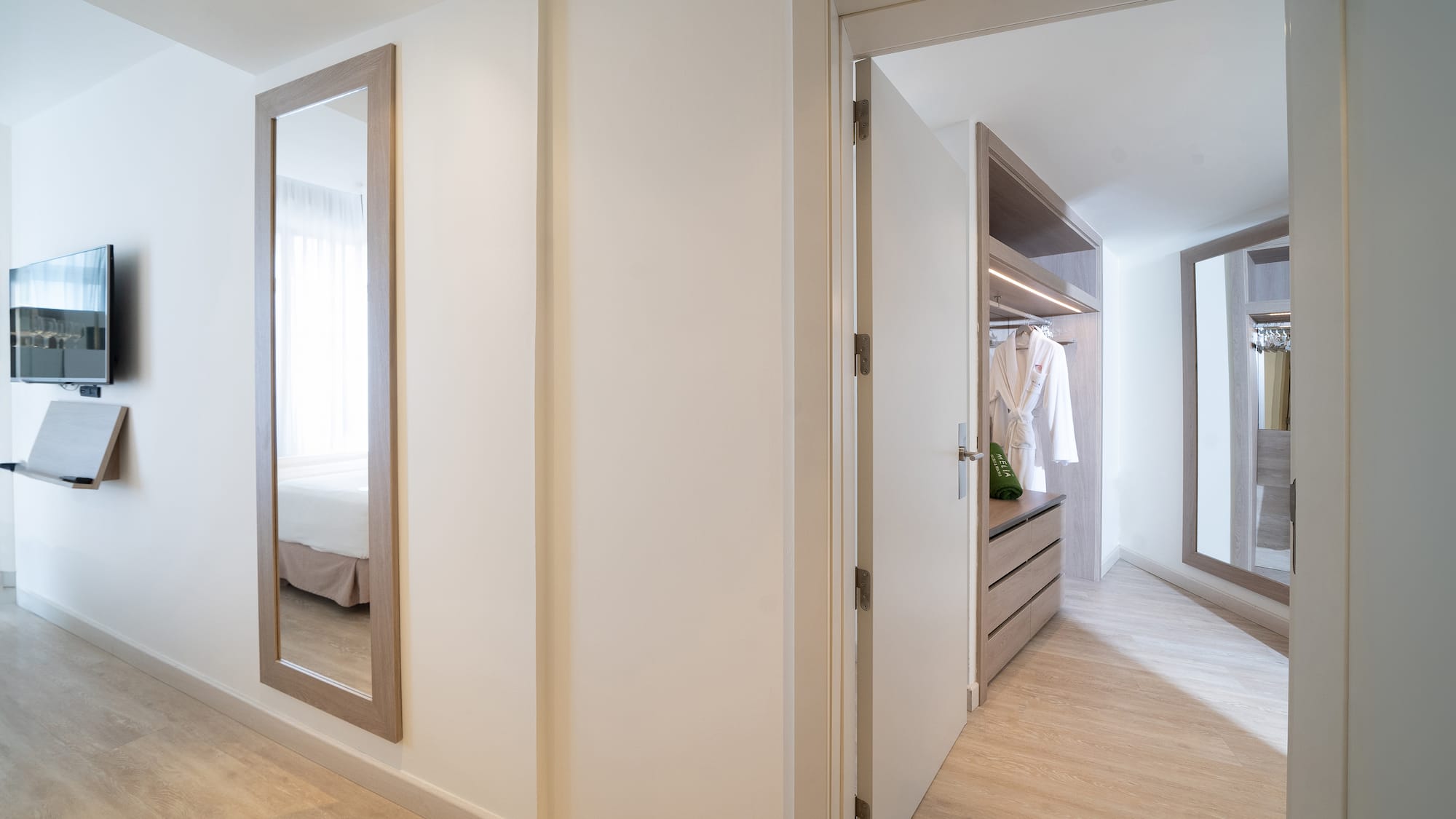 a hallway with a mirror and closet