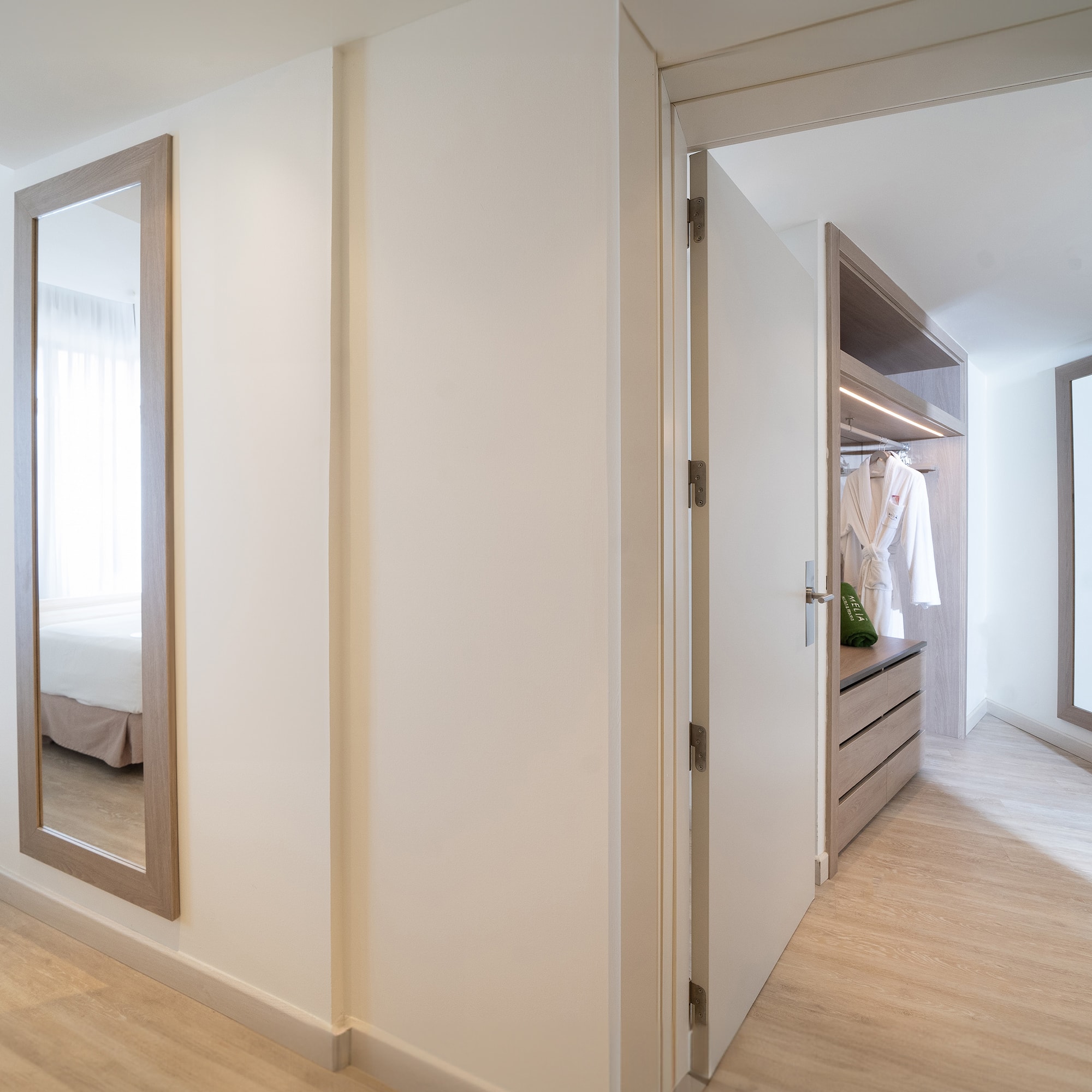a hallway with a mirror and closet