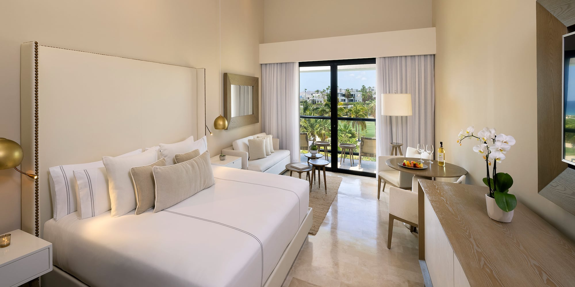 a room with a bed and a table and chairs