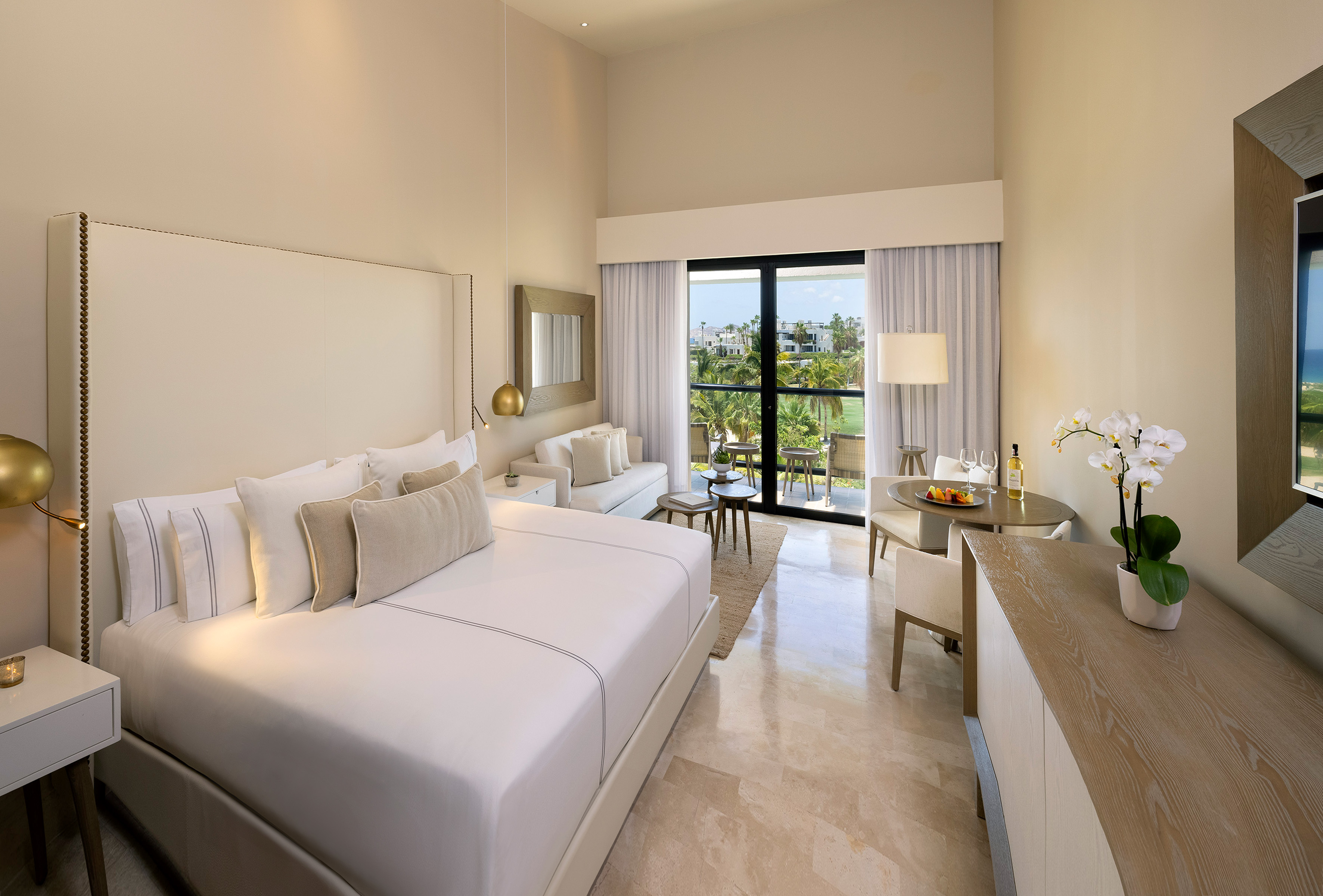 a room with a bed and a table and chairs