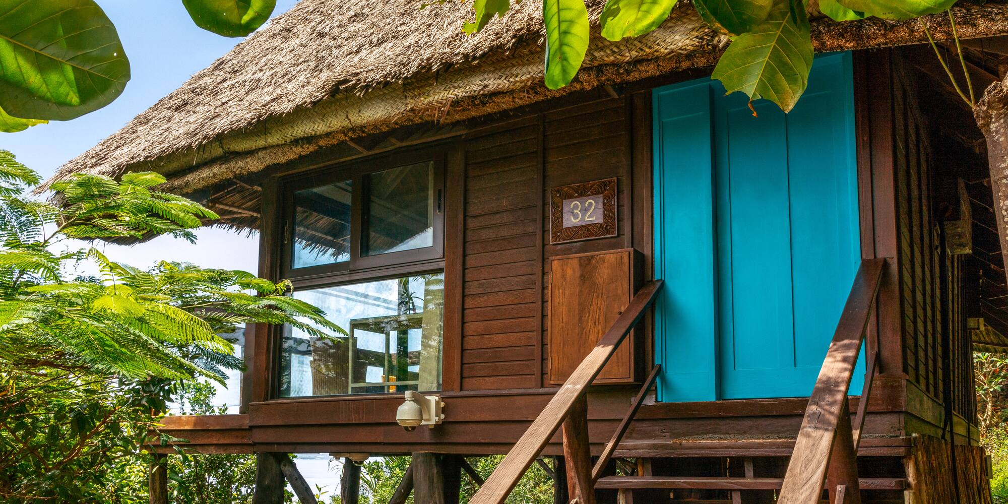 a house with a thatched roof and a thatched roof