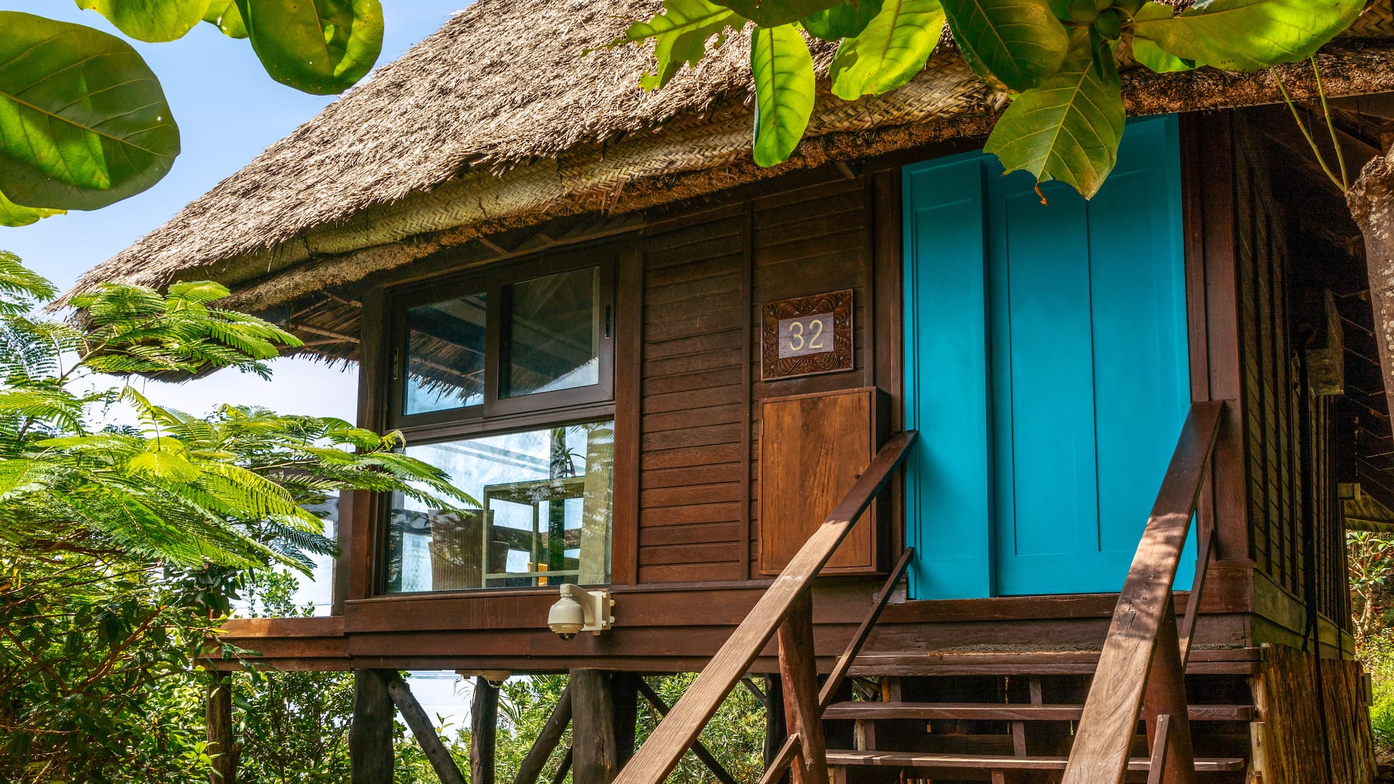 a house with a thatched roof and a thatched roof