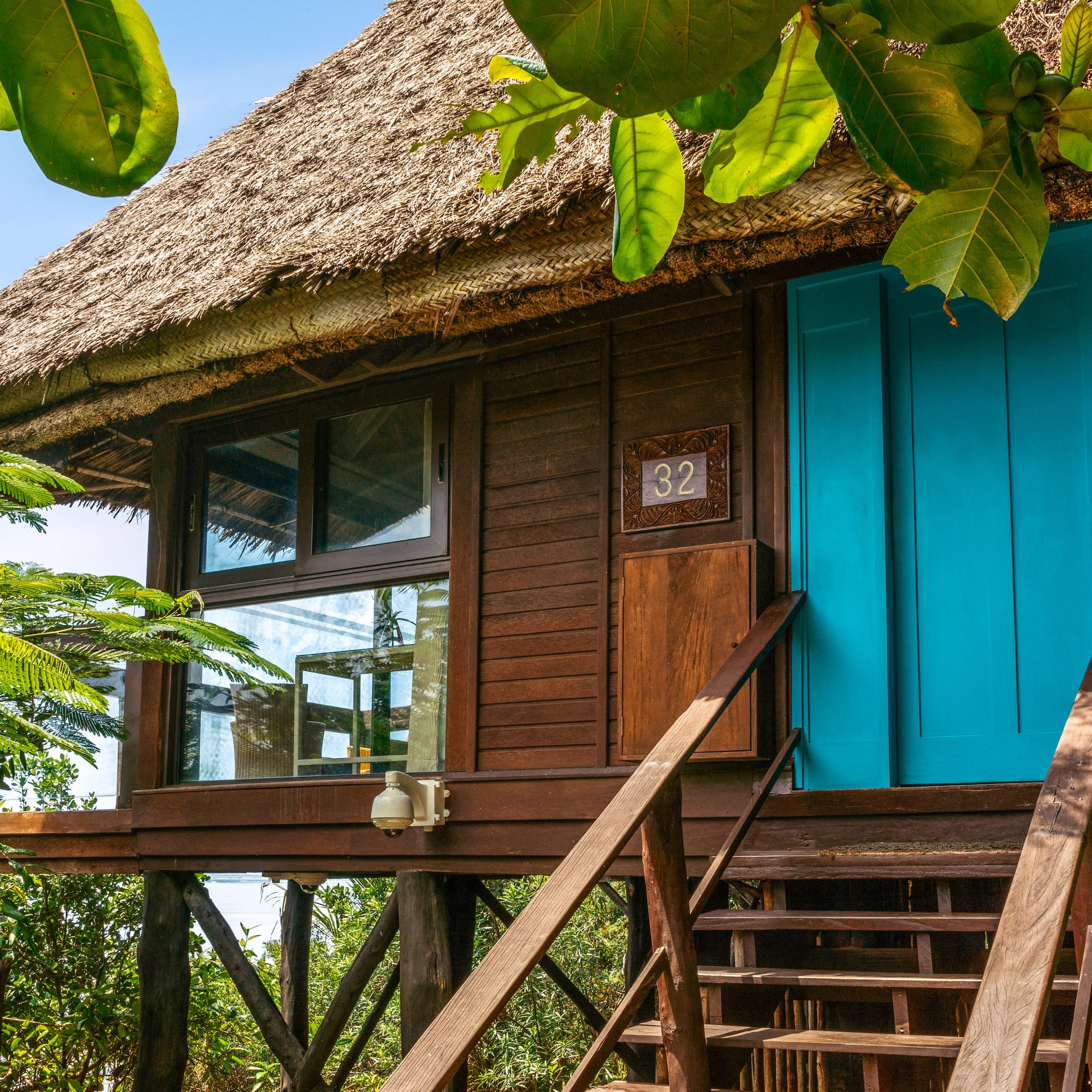 a house with a thatched roof and a thatched roof