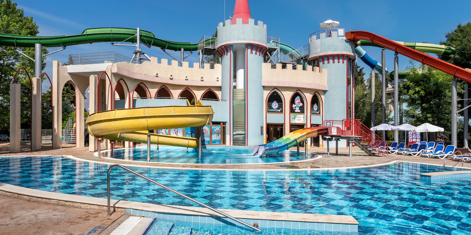 a water park with a castle and a pool
