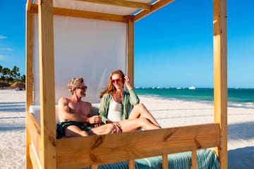 a man and woman sitting on a beach