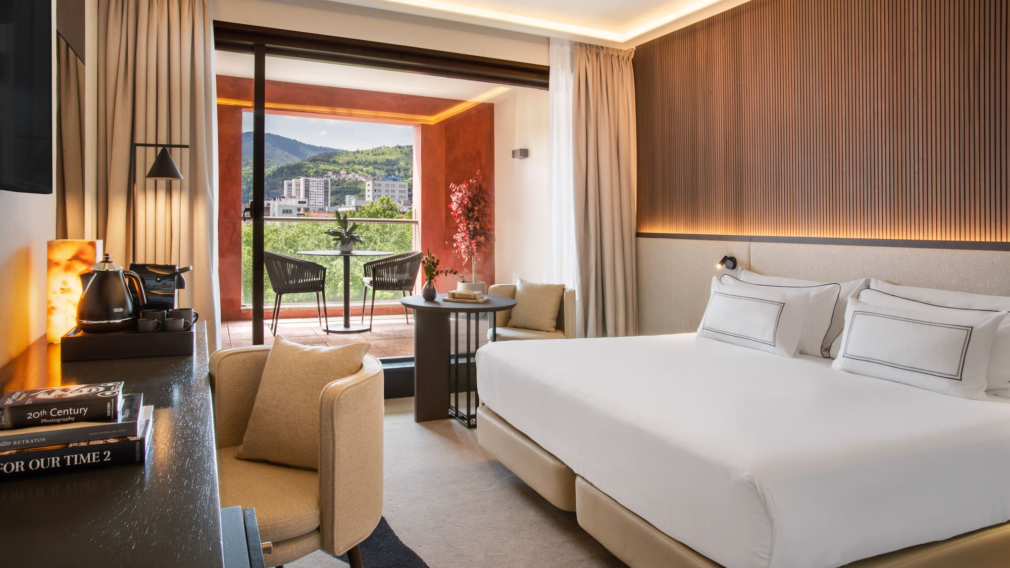 a room with a bed and a table and chairs