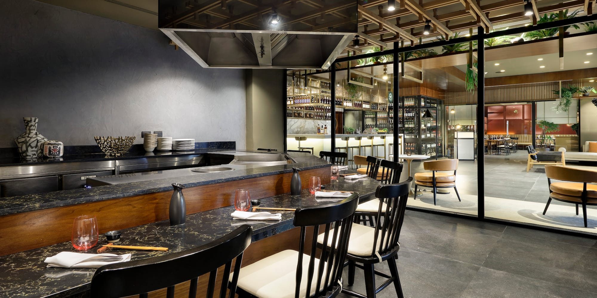 a restaurant with a large counter and chairs